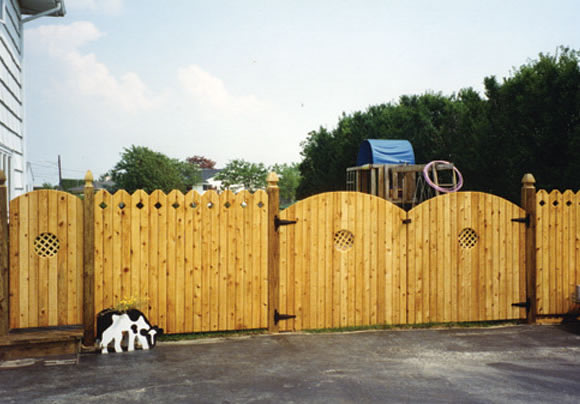 Wood Fence with Lattice Cut Outs and Pointed Posts